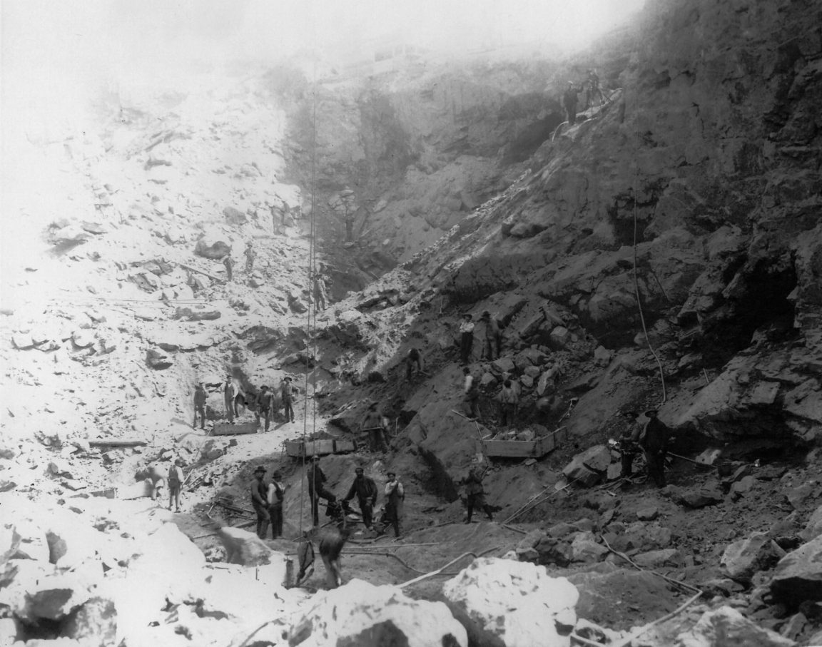 Men mining iron ore at an open pit mine in Lyon Mountain