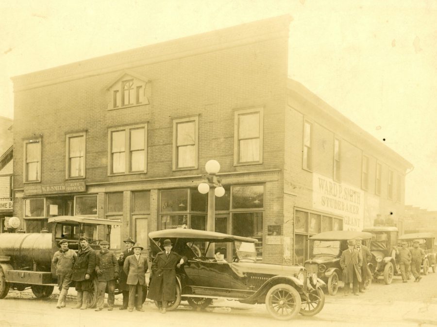 Carthage Auto Supply Company owners in front of the newest cars in