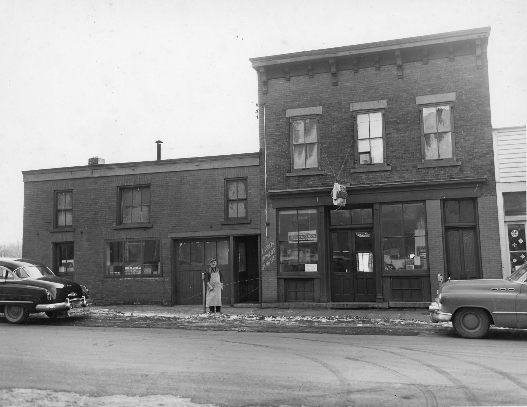 Repairman and decoy maker outside his shop in Ogdensburg