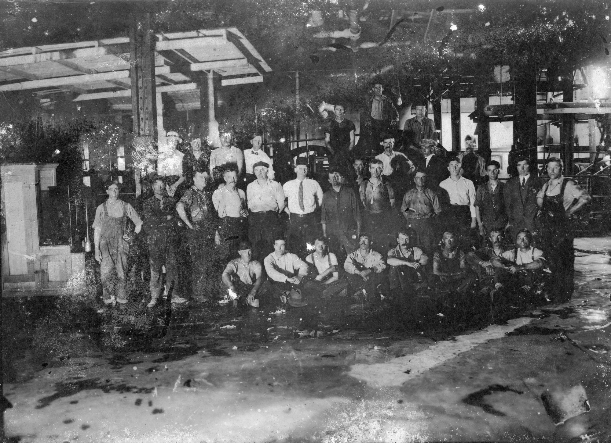 Shipyard employees in front of ship construction and repair space in
