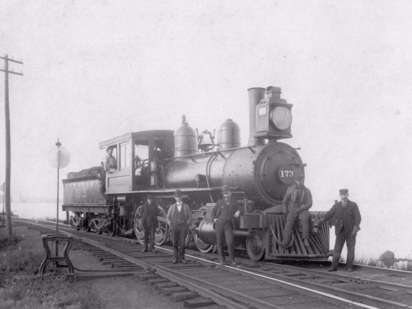 locomotive and crew next to train tracks in Saint Lawrence County