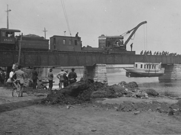 Lowering a logging boat into the Black River in Carthage