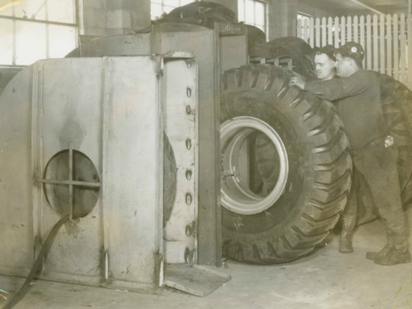 Mechanics with tires inside the garage of the Jones & Laughlin Steel Corporation in Benson Mines