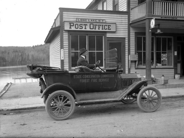 Pat Cunningham driving a NY State Conservation Department Ford Model T in Long Lake