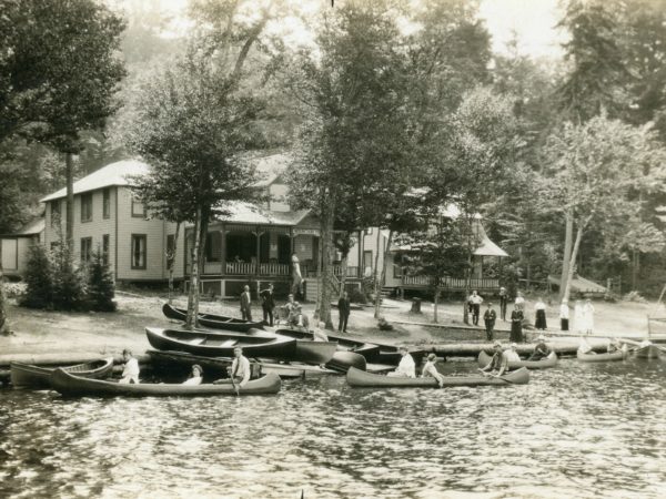 Canoeing outside the Mountain View Hotel and Cottages on Fourth Lake in the Town of Webb