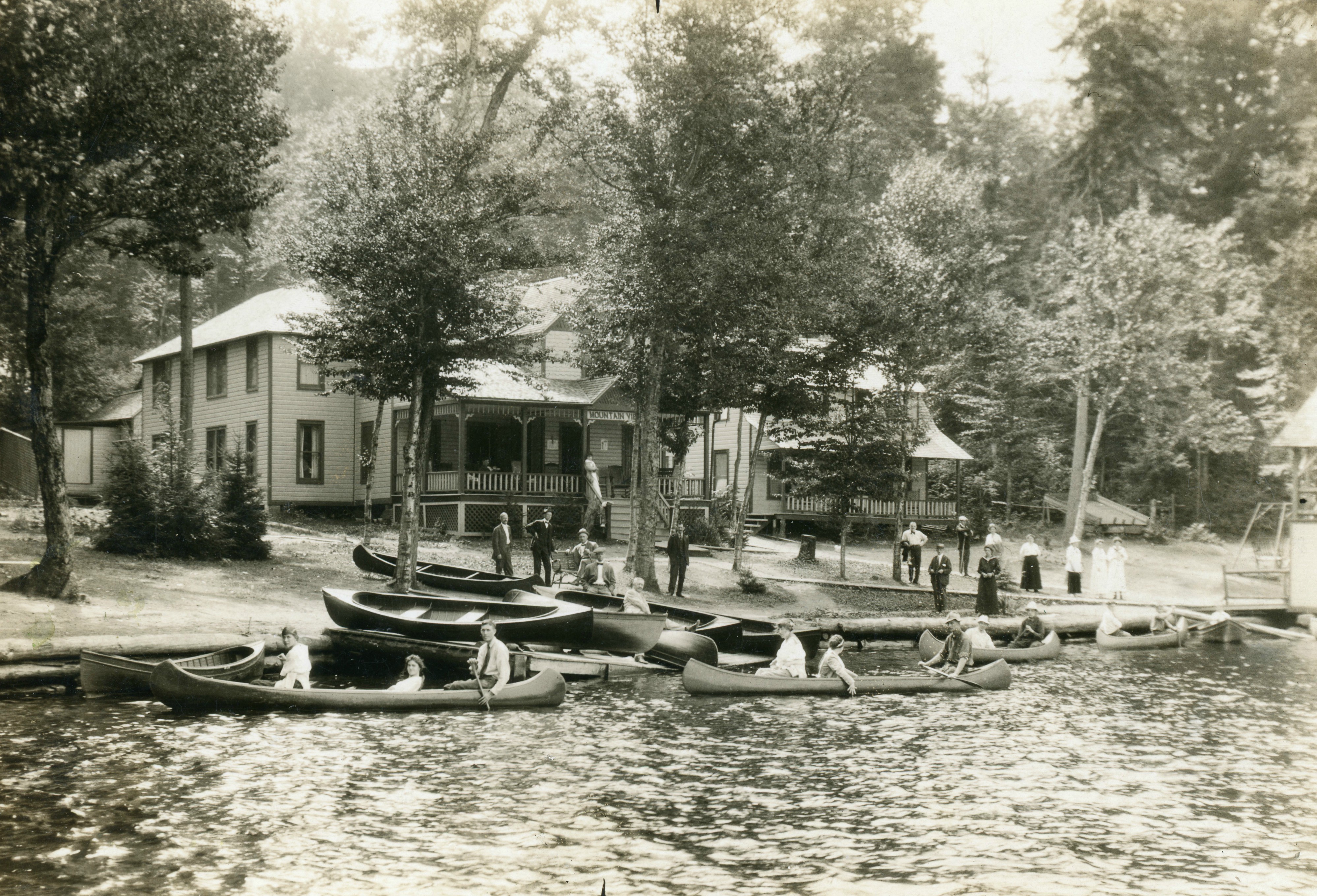 Canoeing outside the Mountain View Hotel and Cottages on Fourth Lake in the Town of b