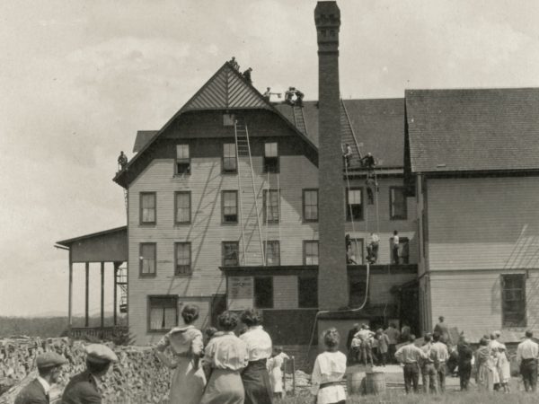 Firemen scale the Old Forge House in Old Forge