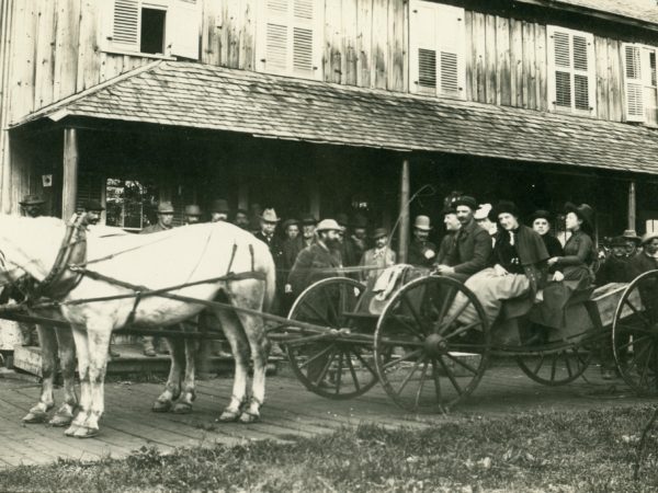 Buckboard spring wagon in front of the Forge House in Old Forge