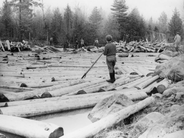 Eight loggers breaking log jam in Town of