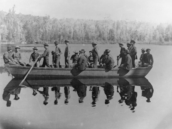 Group of men in an Adirondack skiff in the Adirondacks