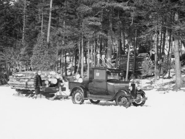 Hauling logs with Model A Ford truck in the Town of Webb