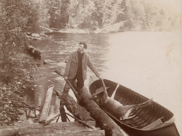 An Adirondack guide and his guide boat at Twitchell Lake in the Town of Webb