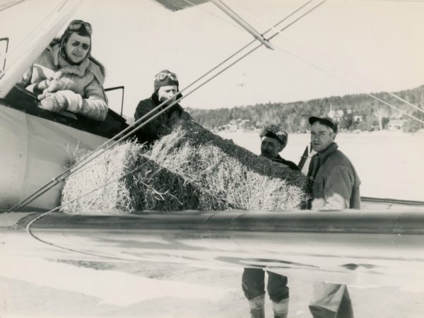 Loading hay onto sea plane in the Town of Webb