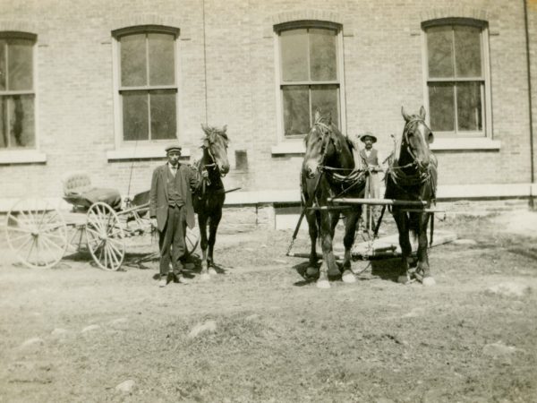 Two men and their horses in De Kalb Junction