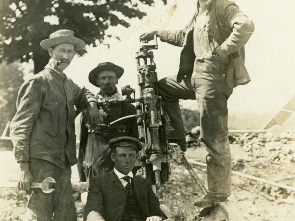 Highway department workers with a steam drill in the Town of De Kalb