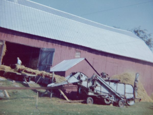 Threshing grain in the Town of De Kalb