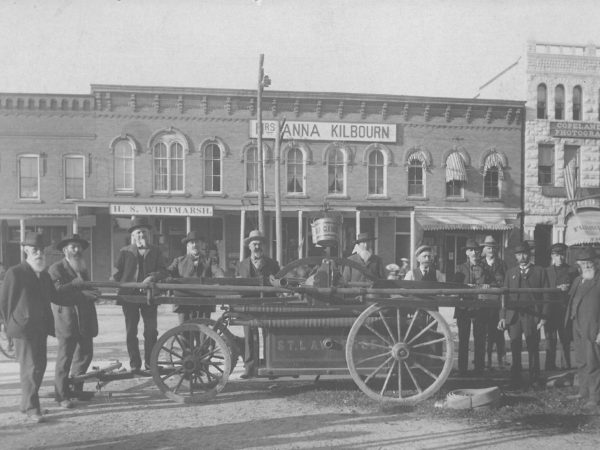 Men gathered around Canton’s first firefighting hand pumper in Canton