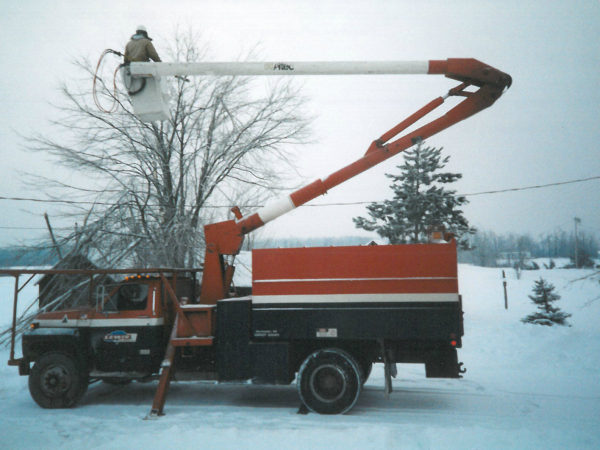 Cutting branches hanging on a power line after 1998 ice storm in Canton