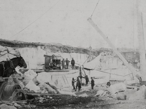 Men working with a steam drill in the Canton Marble Quarries