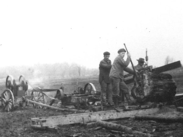 Cutting a tree trunk with hit or miss engine powered drag saw on Wallace Farm in Canton