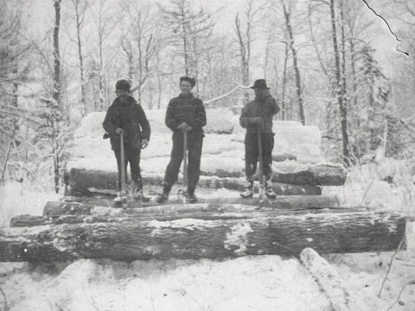 Trio of loggers at log yard in Canton