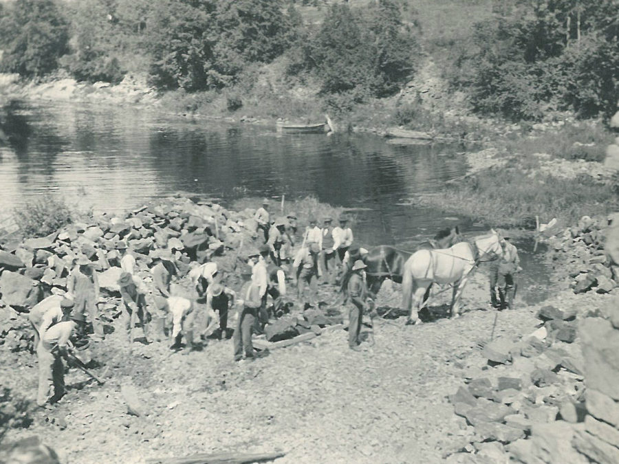 Man in the sheep and cow corral at Beaver Meadow farm in North Creek
