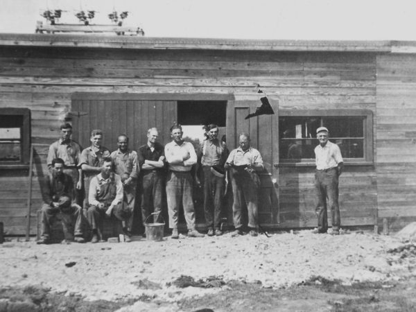 Workmen in front of a building at the Green Hill Mine in De Kalb