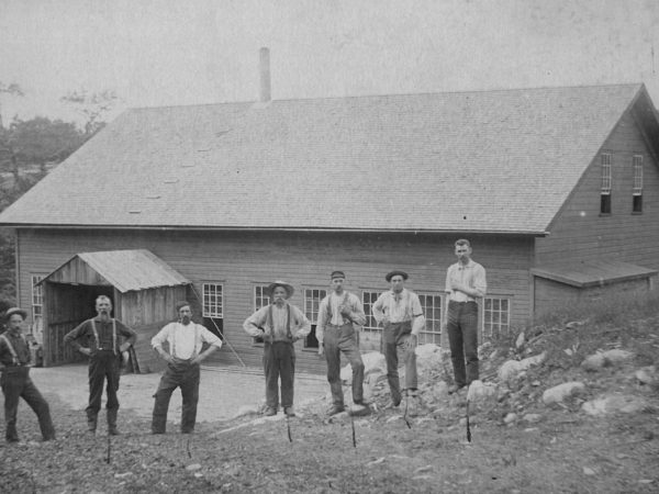 Employees in front of a wood pulp mill in Edwards