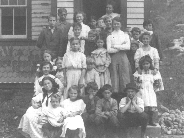 Schoolchildren and their teacher in front of the Star Lake School in Oswegatchie