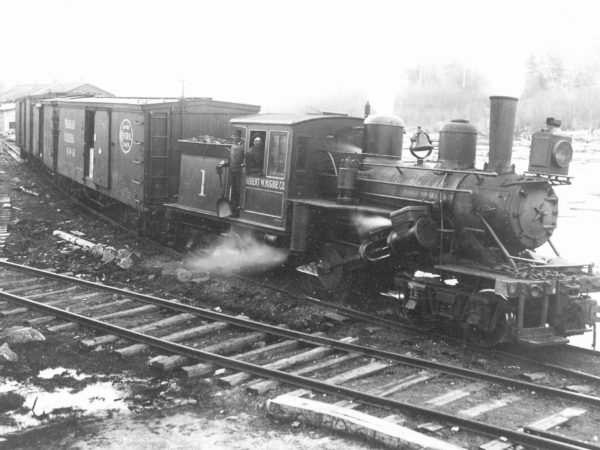 Lumber company workers on steam locomotive in Newton Falls