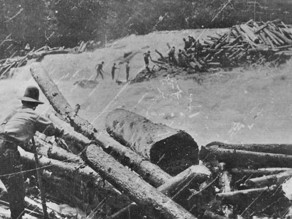 Loggers during a spring log drive on the Racquette River in Colton