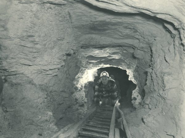 Miners climbing ladder out of talc mine in Talcville