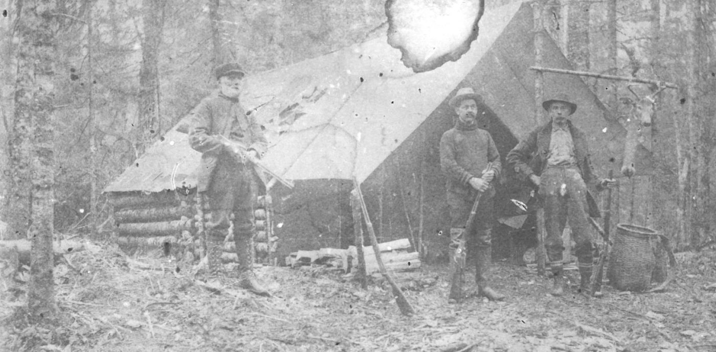 Hunters outside a hunting camp in Fine