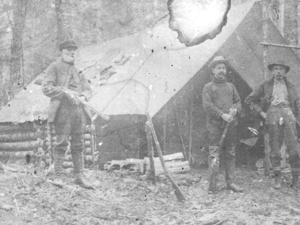 Hunters outside a hunting camp in Fine