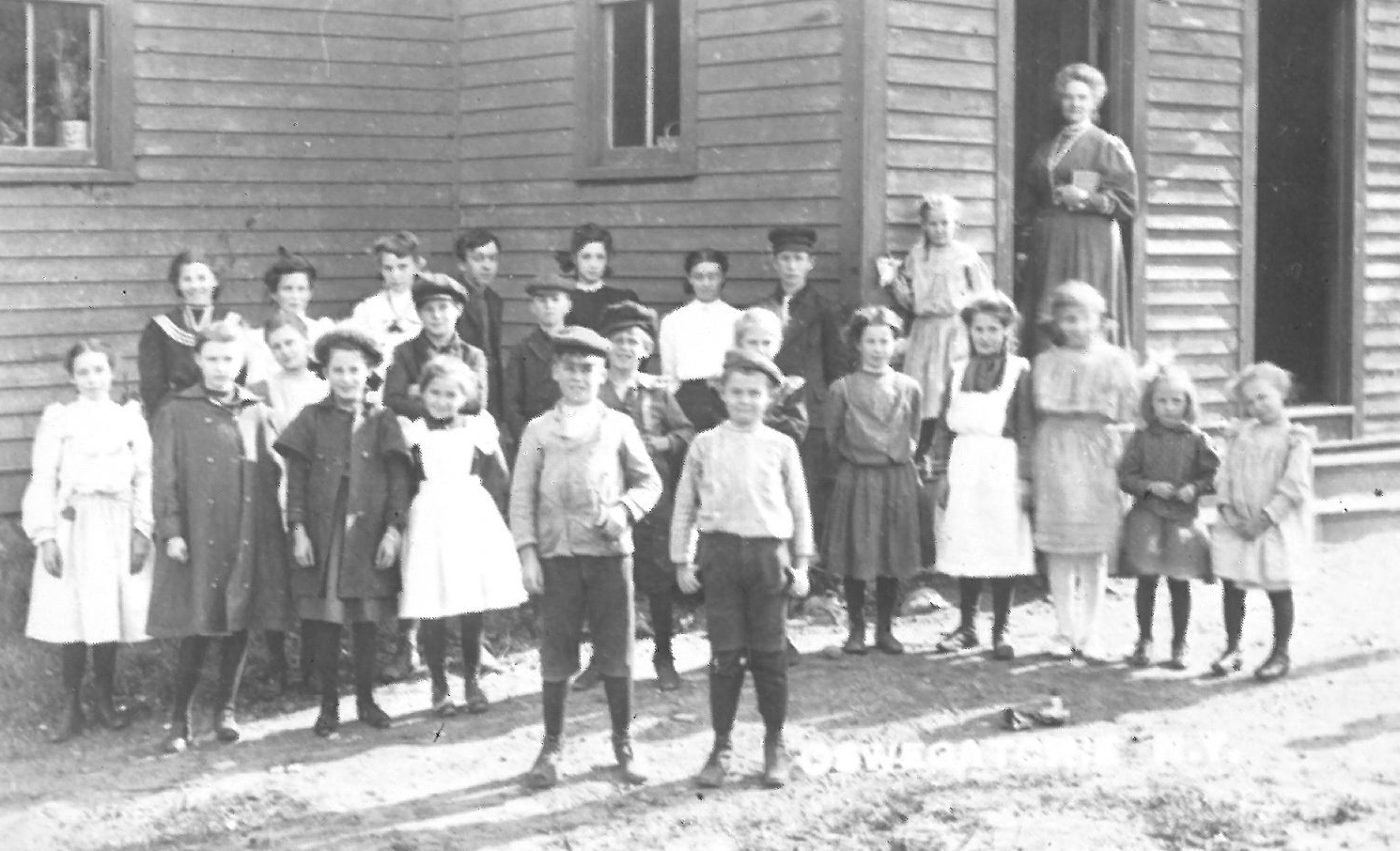Students and teacher outside the Oswegatchie Union School in Star Lake