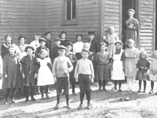 Students and teacher outside the Oswegatchie Union School in Star Lake