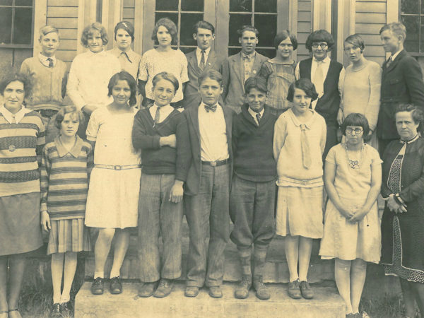 Students and two teachers at the entrance of the Oswegatchie Union School in Star Lake