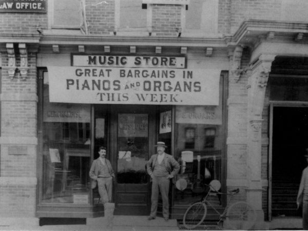 Professor Sudds in front of his music store in downtown Gouverneur