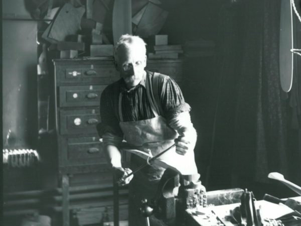 Nelson Brown shapes a boat piece in his shop in Rushton Boat works