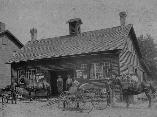 Men in front of the Sutherland Blacksmith Shop in Stockholm