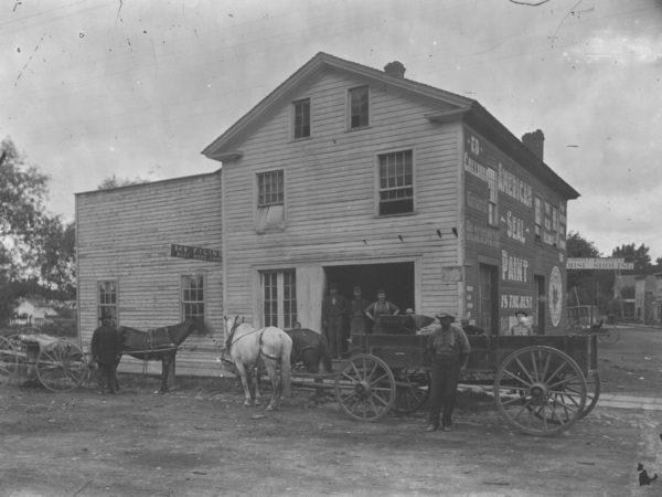 Men outside the Main Street Blacksmith Shop in Canton