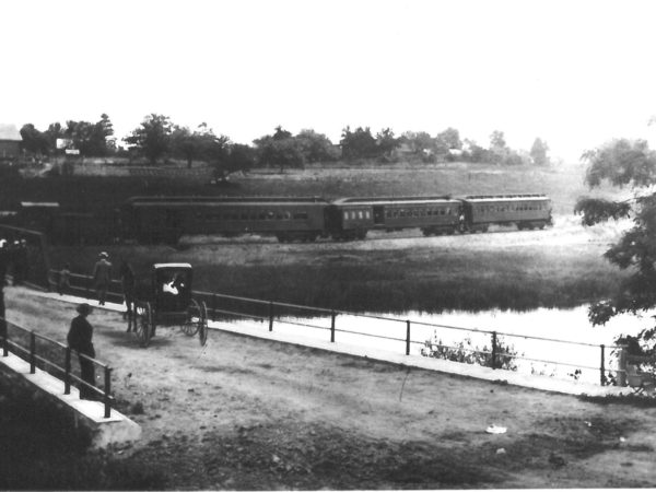 People watch as the first train comes into Waddington