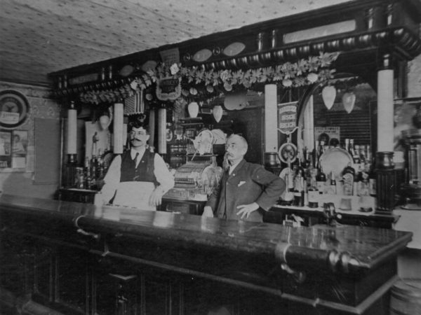 Menard and Erwin behind the bar at the Erwin House Bar in Canton