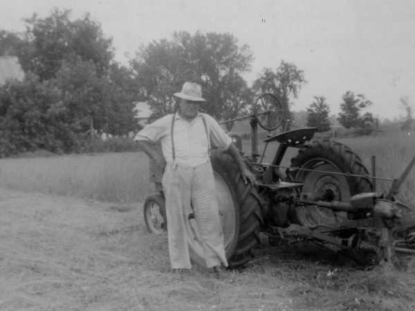 Frank Squire using John Deere tractor to cut hay in Hopkinton