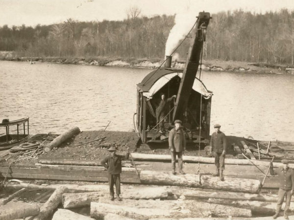 Barnhart Loader moving logs at Chair Rock Bay in Cranberry