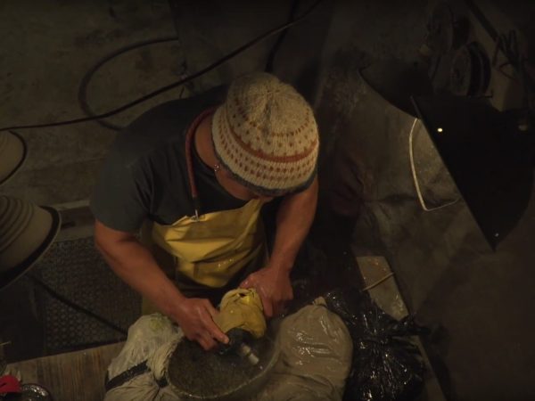 Sculptor Matt Horner polishing a stone bowl in his workshop in Keene