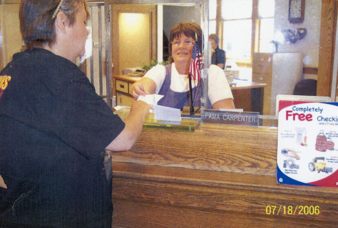 Connie Green working as a bank teller in the Hermon Community Bank in