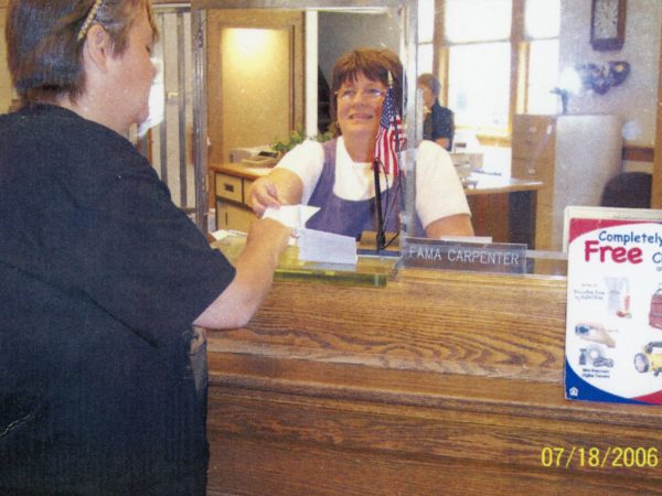 Connie Green working as a bank teller in the Hermon Community Bank in Hermon