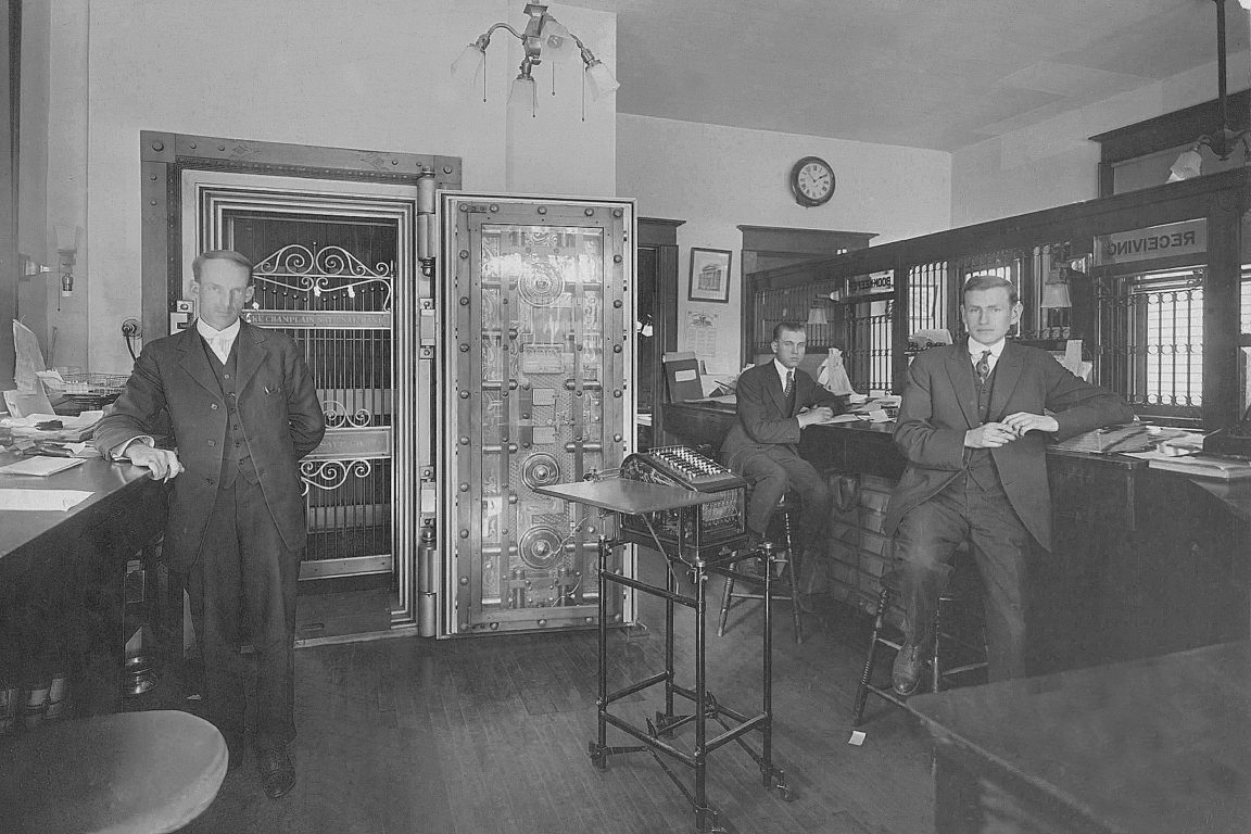 Three male tellers inside the Lake Champlain National Bank in Westport