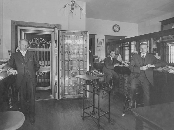 Three male tellers inside the Lake Champlain National Bank in Westport